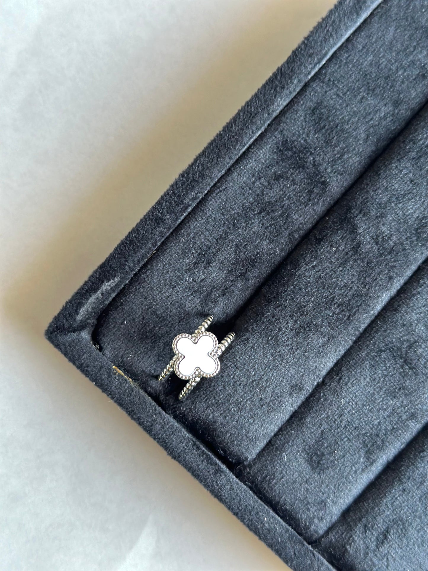 Silver colored vancleef ring